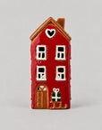 Ceramic House sleigh by the door