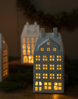 Decorative house-shaped lanterns with warm glow on a dark background