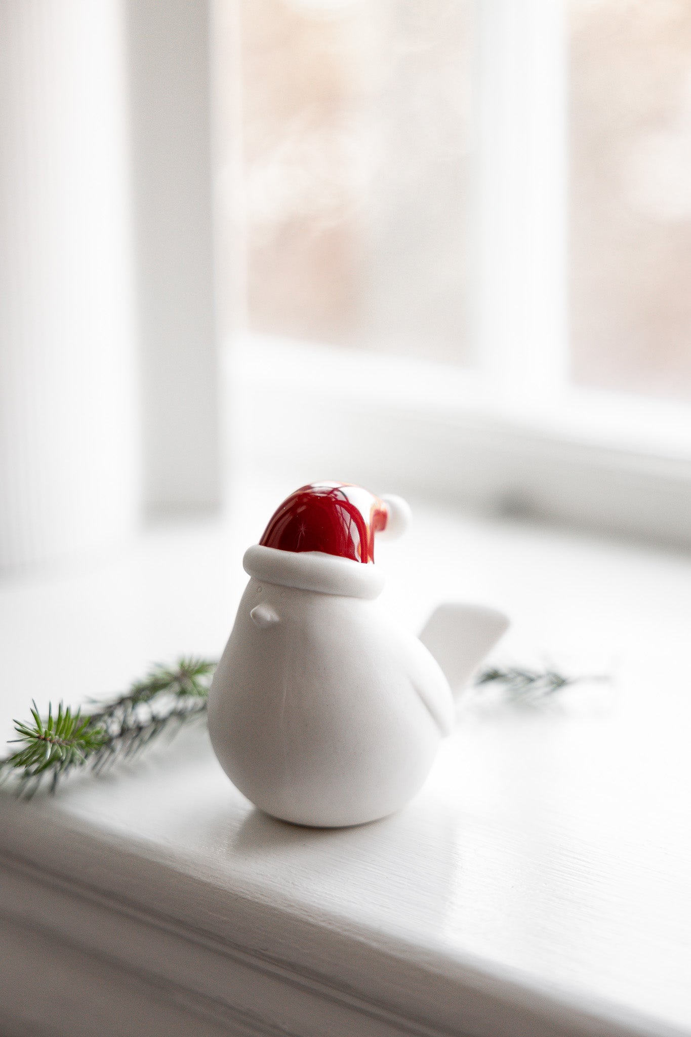 Ceramic bird with red hat