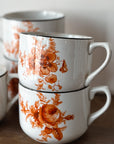 Vintage coffee cups with with antique orange floral pattern