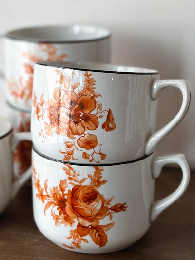 Vintage coffee cups with with antique orange floral pattern