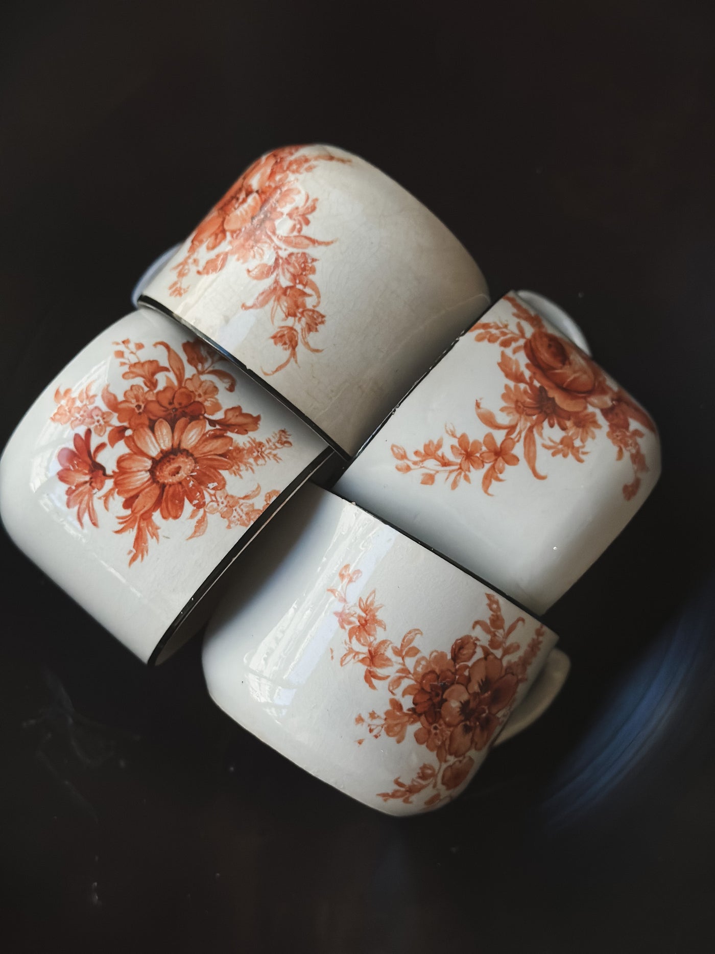 Vintage coffee cups with with antique orange floral pattern