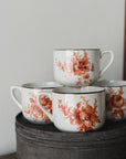 Vintage coffee cups with with antique orange floral pattern