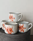 Vintage coffee cups with with antique orange floral pattern